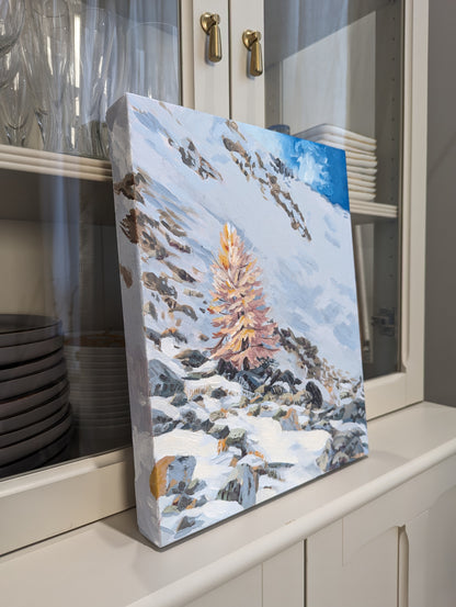 a snowy larch tree on a snowy rocky mountain painting